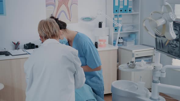 Dentistry Team Performing Tooth Extraction in Stomatology Cabinet