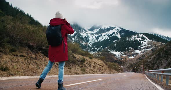 Young Woman Travel Photographer Walk on Empty Mountain Road Making Photo