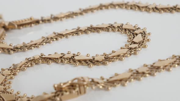 Panning over  detailed golden necklace chain 4K video