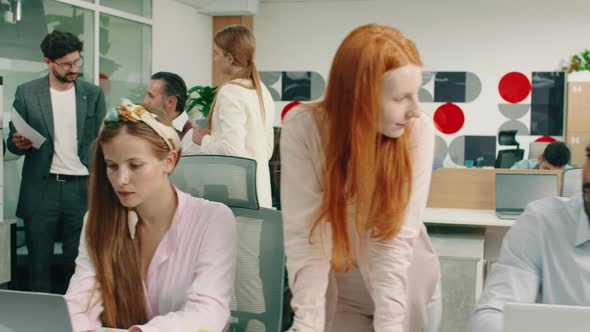 A Moving Shot of Three Colleagues in an Office are