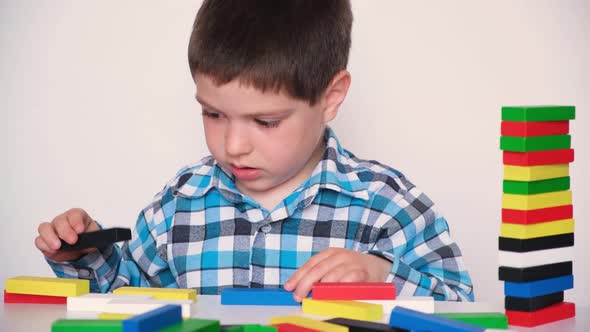 Preschool Boy Plays Colorful Details of the Board Game Jenga Destroys the Tower and Talks