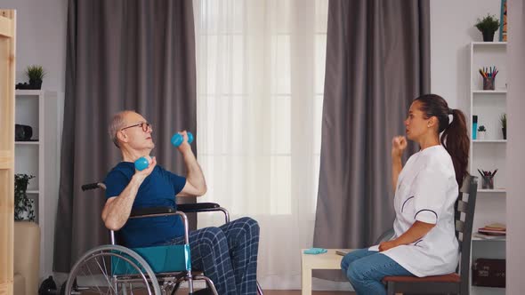 Old Patient in Wheelchair Doing Recovery Exercises