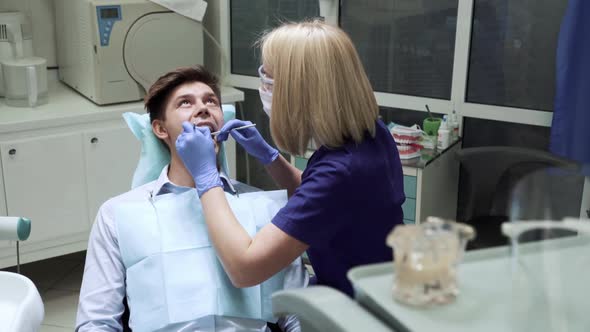 Dentist Carrying Out a Thorough Examination
