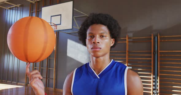 Portrait of african american male basketball player holding ball