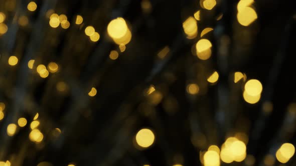 Yellow Bokeh Lights Shimmering. Shiny Christmas Blurred Lights. Abstract Particles Background