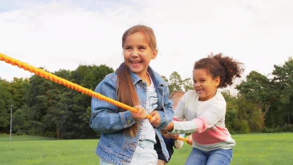 Happy Children Playing Tugofwar Game at Park