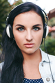 young stylish woman walking, listening to music on headphones - PhotoDune Item for Sale