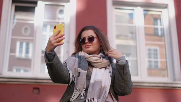 Woman in Sunglasses Does Selfie in the Street of Old Town in Autumn  60p Slow Motion