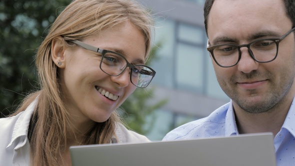 Happy Business Couple Using Laptop Outdoor.