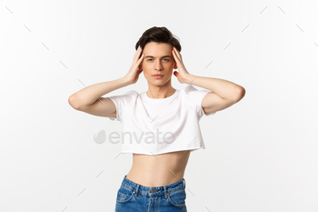 Lgbtq and pride concept. Beautiful and confident gay man wearing crop top, touching face and looking / Photodune, Misc