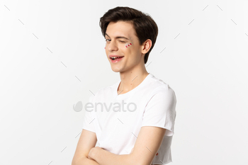 People, lgbtq and beauty concept. Beautiful cheeky gay man winking at camera and smiling, standing / Photodune, Misc