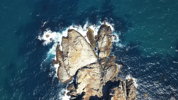 waves crashing cliffs view from drone shot