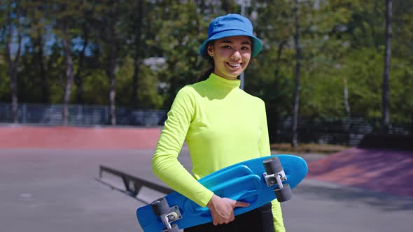 Smiling Beautiful Asian Lady in a Urban Skate Park