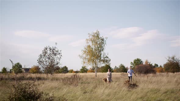 Young Couple Walking on a Meadow