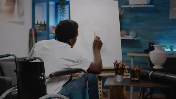 Black Person with Handicap Using Pencil on White Canvas