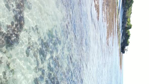 Vertical Video of the Ocean Near the Coast of Zanzibar Tanzania Aerial View