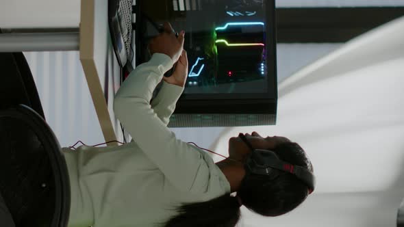 Vertical Video Black Woman Gamer Winning Videogames Using Professional Wireless Controller