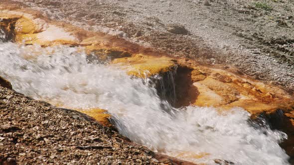 Slow Motion Hot Water Stream in Volcanic Geyser Basic Iron and Cooper Mineral