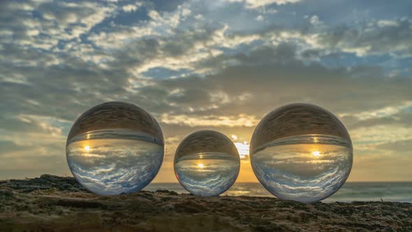 Time Lapse View Of The Beach In Sunset Inside Crystal Balls.