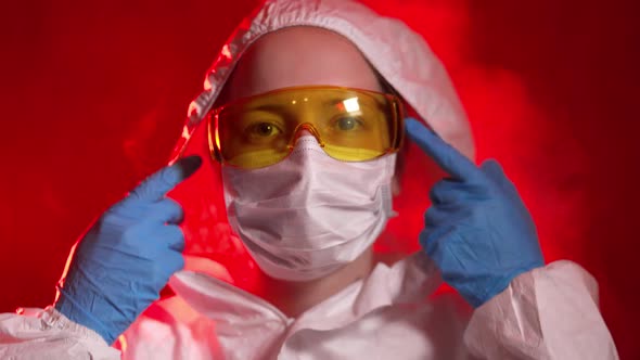 An Infectious Disease Doctor Puts on a Protective Suit and Mask To Work with Infected Patients