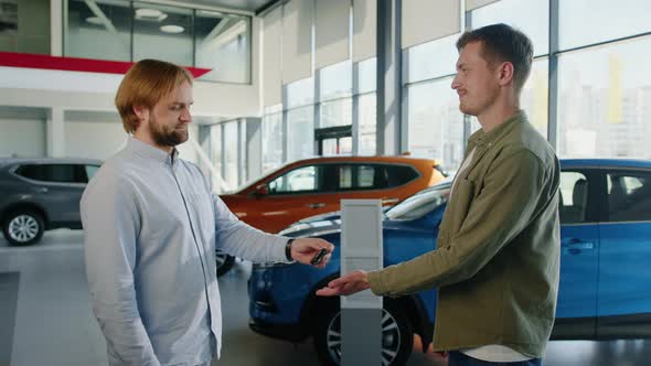 Dealership Manager Hands Over the Keys to a New Car