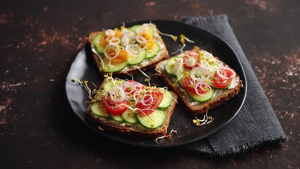 Healthy Toasts with Cucomber, Tomatoes and Crumbled Feta and Radish Sprouts