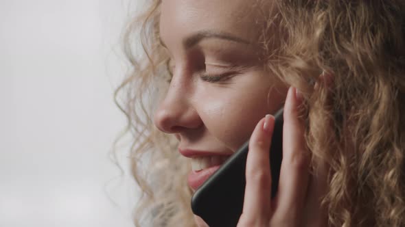 Extreme Close Up Shot of a Young Adult Caucasian Woman Talking on a Phone Indoors