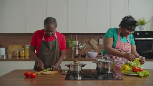 Senior African Couple Cooking Together in Kitchen