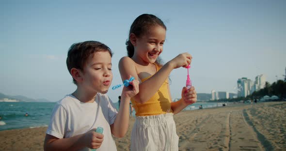 Happy Children Playing with Soap Bubbles