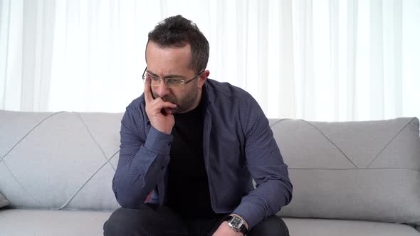 Thoughtful man at home, alone.