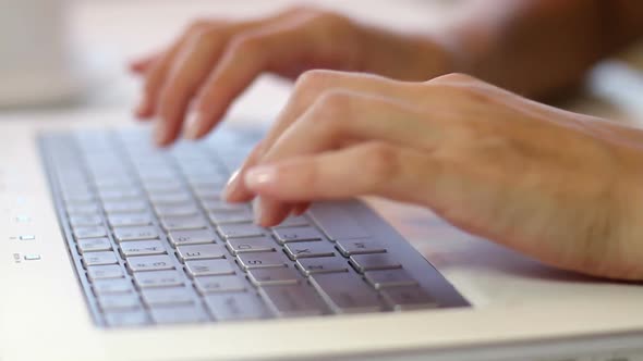 Typing on a Keyboard. Female hands. 3 different shot angles. Loopable.