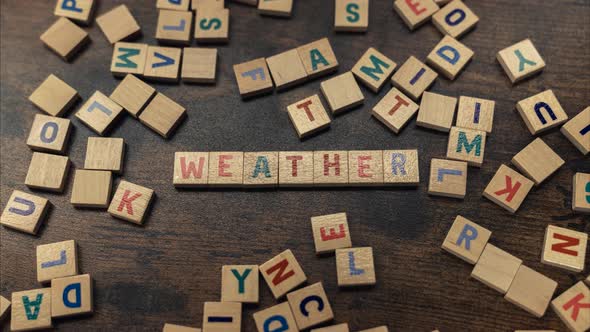 Weather Word Written From Wooden Block Letters  Zoom in Shot