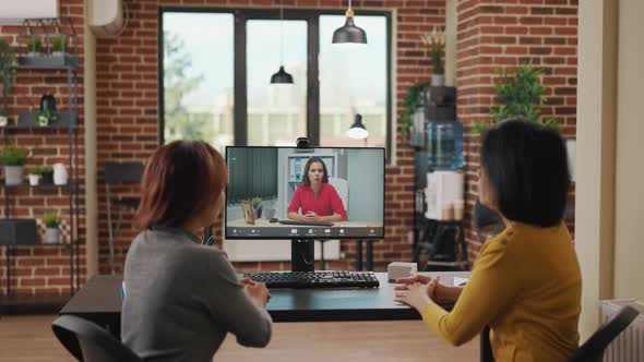 Colleagues Using Video Call Conference to Recruit Woman