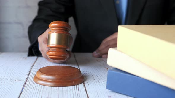 Close Up of Person's Hand Striking the Gavel.