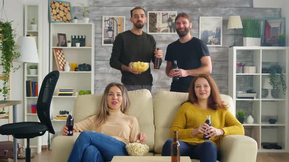 Girls Sitting on Couch Eating Popcorn While Watching Tv