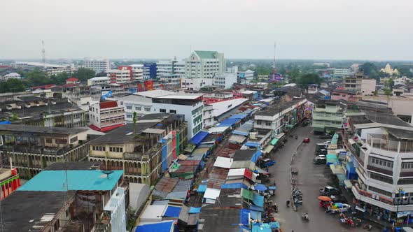 Aerial view of Rom Hoop market. Thai Railway with a local train run through Mae Klong Market