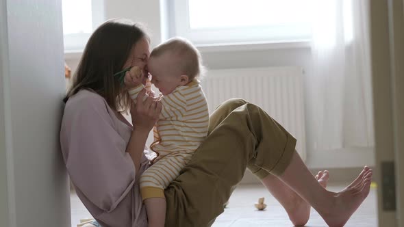 Little Baby Girl and Mommy Playing at Home Sitting on Floor