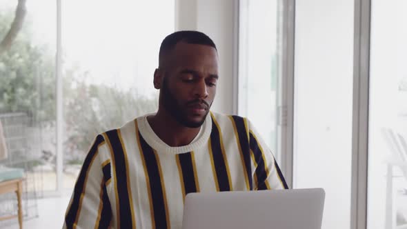 Young adult mixed race man enjoying time at home