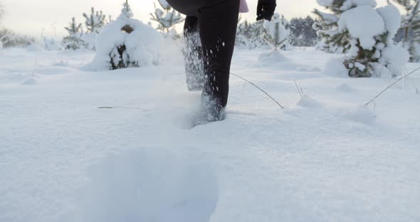 Woman Walking in Deep Snow on Sunny Winter Day Close Up Slow Motion