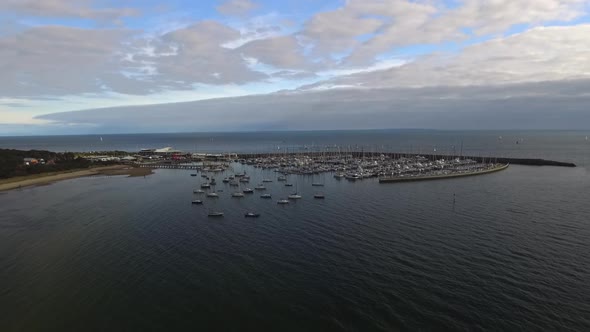 Drone aerial view of Port Phillip Bay in Hampton, Melbourne Australia. Day time clouds in sky.