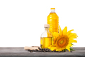 Bottles of sunflower oil with seeds and sunflower on wooden table isolated on white background - PhotoDune Item for Sale