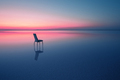 Chair among smooth water of lake at the sunset - PhotoDune Item for Sale