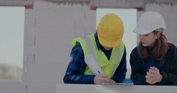 Confident Male Worker Discussing with Female Contractor