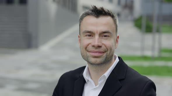 Close Up View of Positive Mature Businessman Looking To Camera