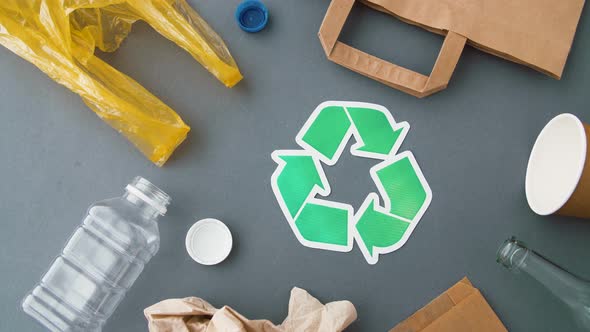Green Recycle Symbol with Household Waste on Grey 16