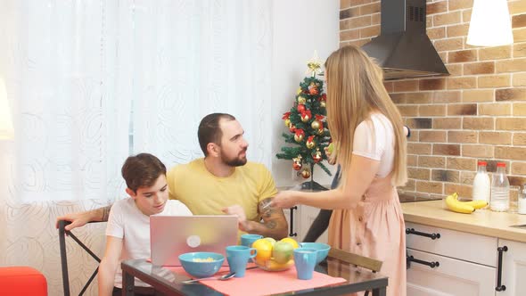 Careful Parents and Cute Kids Together in Kitchen