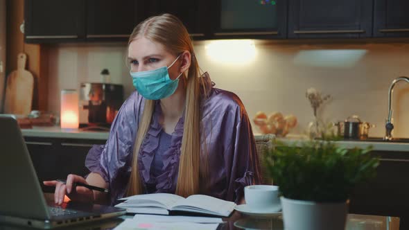 Young Business Woman in Protective Mask Working at Home on Quarantine