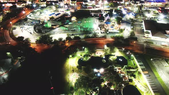 Blinking and glowing bright lights of Orlando amusement park - Old town. Aerial tilt up view