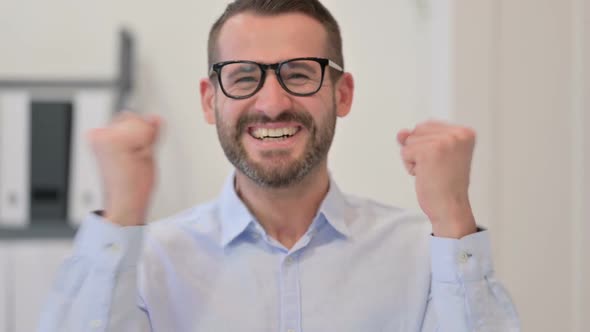 Portrait of Middle Aged Man Excited By Success Winning