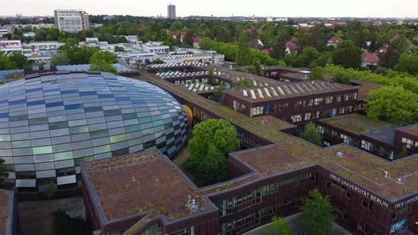 Lettering Freie Universität Berlin, Glass dome library, solar systemAmazing aerial view flyover dro